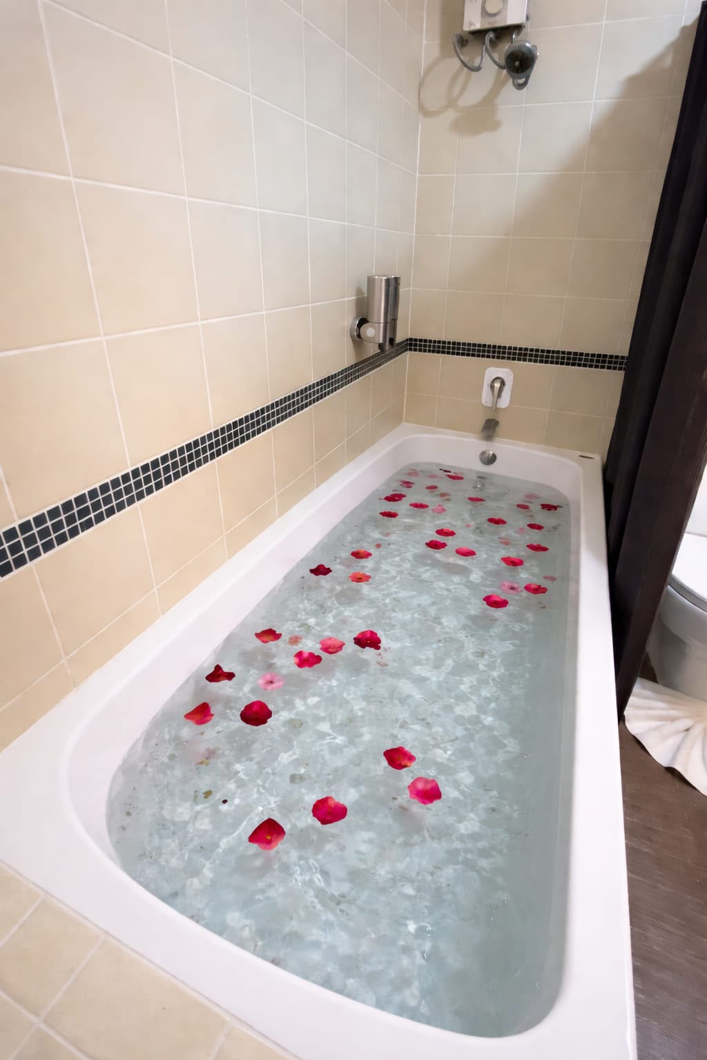 Romantic bathtub decorated with rose petals