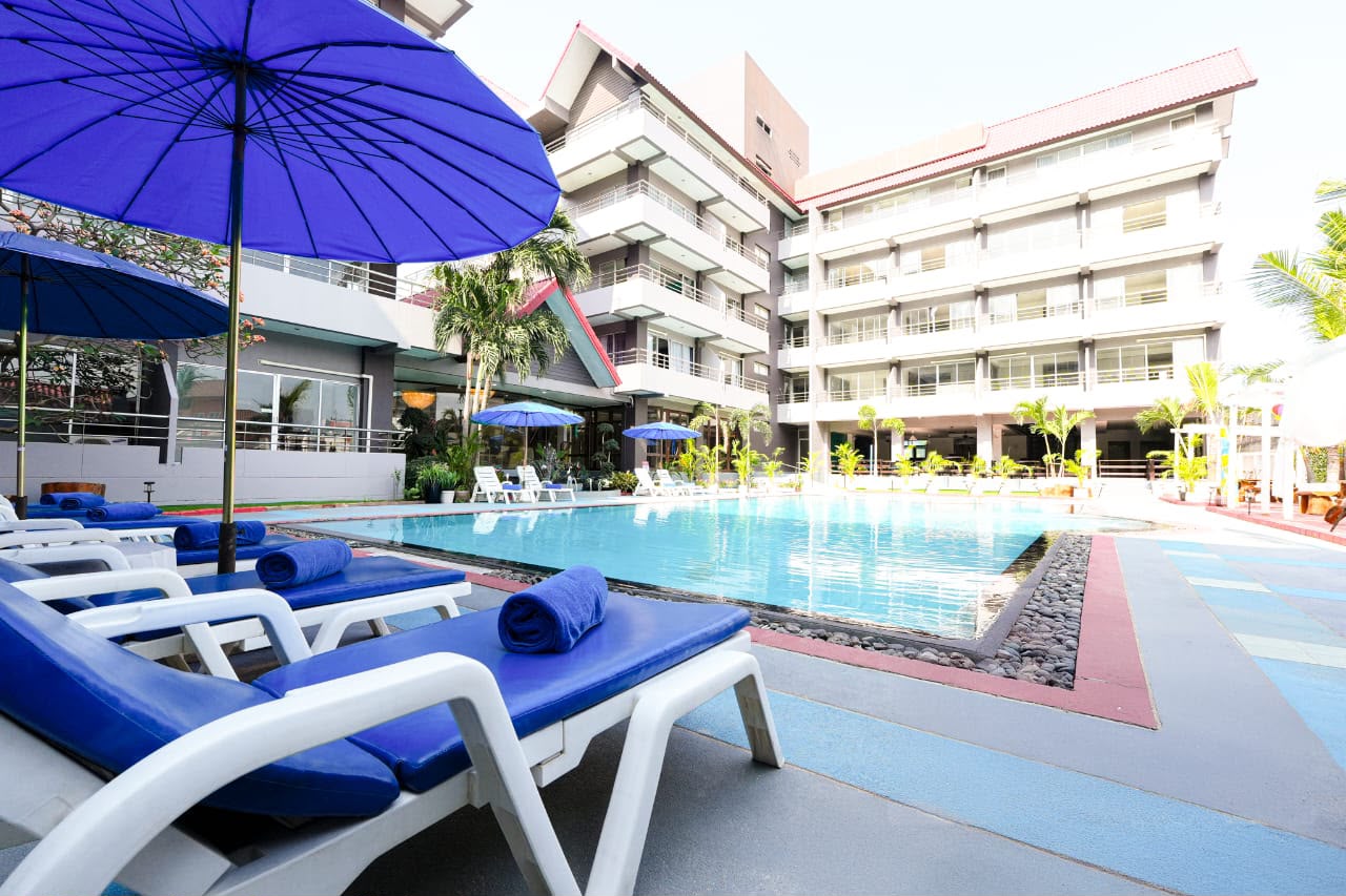 Pool area with sunbeds and umbrellas
